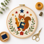 Completed Notebook Squirrel Mini cross stitch pattern shown stitched in a hoop with floss styling by Calico & Clove